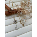 Collier clé diamant blanc