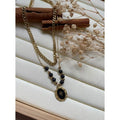 Collier avec soutoir en agates noires et doré